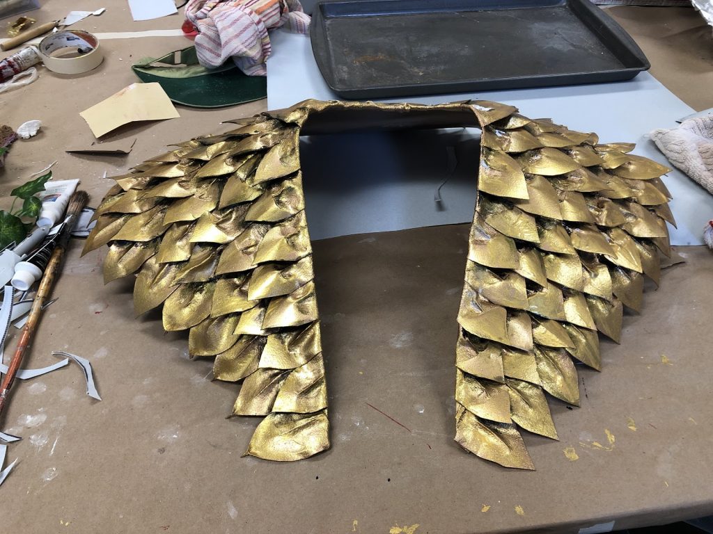 Gold feather shoulder piece for a costume